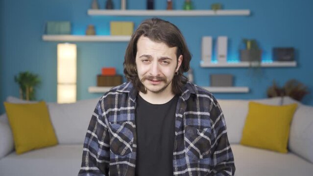 Unhappy man crying looking at camera. Gestures. 
Unhappy man crying.
