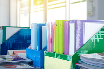 Colorful folders of personnel and office staff are kept and sorted in boxes in the office to...
