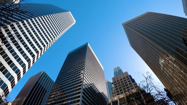 Corporate building and glass skyscrapers in business district downtown. Skyscrapers in San Francisco in the financial district. Skyward view of city buildings. Corporate building and glass skyscrapers