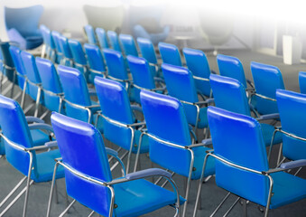 blue chairs in ordinary empty waiting room. Selective focus