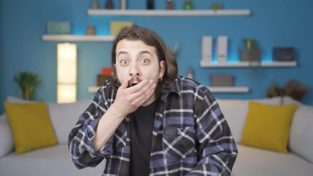 Confused man, his eyes look big. Gestures.
Surprised man looking at camera with big eyes.

