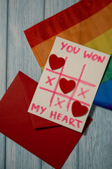Handmade valentine with Text YOU WON MY HEART and tic tac toe game red envelope and LGBTQ flag....