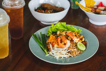 Pad Thai in a beautiful dish on a wooden table