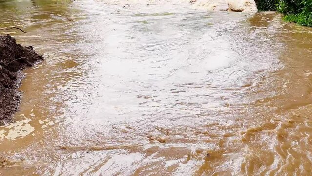 Tilting shot revealing the muddy flooded river in Caimito district, Panama Province, Panama