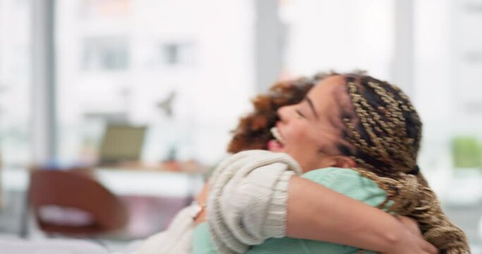 Happy, celebration and women friends hugging after winning an online gaming bet or good news. Happiness, friendship and females embracing to celebrate a job promotion in the living room of their home