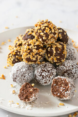No bake paleo chocolate fat bombs on a white plate.