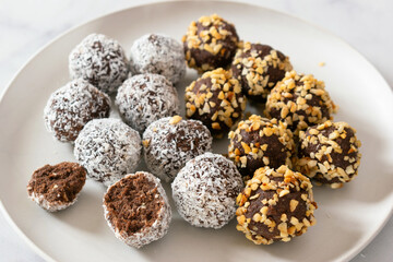 No bake paleo chocolate fat bombs on a white plate.