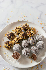 No bake paleo chocolate fat bombs on a white plate.