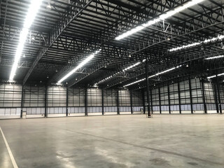 New warehouse for your business, Big Room for Product stock. Lighting on  empty warehouse