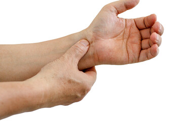 Close-up of a man's arm holding a sore wrist from long hours of work on a computer and laptop. Concepts of carpal tunnel syndrome, arthritis, and neurological disorders. numbness in one's