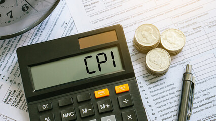CPI, consumer price index symbol.word cpi on the calculator with coins, pen. consumer price index on dollar bills. Business and CPI, consumer price index concept.