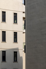Part of the facade of a modern building with rectangular windows.