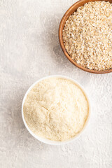 Powdered milk and oatmeal, baby food mix, infant formula on gray concrete, top view