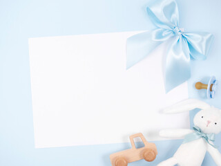 Obraz premium Blue bow, toys, soother on blue background.
