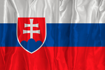 The flag of Slovakia on a silk background is a great national symbol. Texture of fabrics The official state symbol of the country