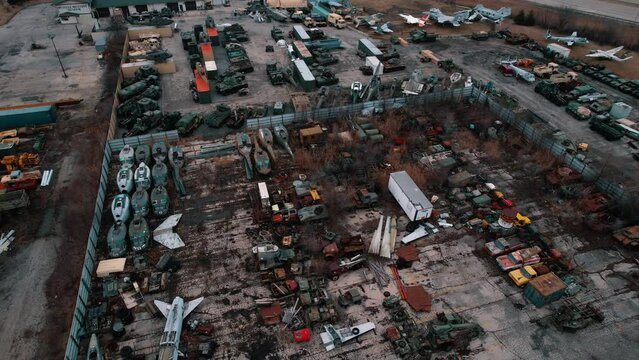 Aerial overvirew of rare old military aircafts, tanks, fighting vehicles, combat equipment, helicopters.  Yard full of weapons of mass destruction weapons. Aerial 4k USA
