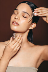 Applying face serum for a radiant complexion and flawless skin