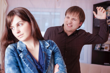 Family Abuse Concepts. Young Caucasian Couple Quarrel Indoors.