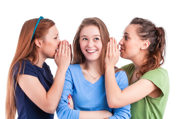 Communication Ideas. Three Smiling Winsome Caucasian Girlfriends Sharing Their Secrets Whispering to Ears Isolated Over White