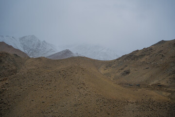Beautiful view mountain and street view of Khardung La Pass- Leh road on the high mountain covered with snow. It is the highest pass in the world that motorbikes can run through at Ladakh, Leh, India