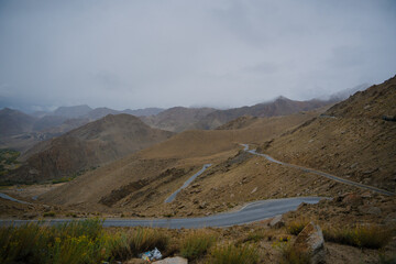 Beautiful view mountain and street view of Khardung La Pass- Leh road on the high mountain covered with snow. It is the highest pass in the world that motorbikes can run through at Ladakh, Leh, India