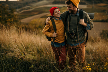Father and son together hiking on the hills: outdoor adventure. Father hugging his son