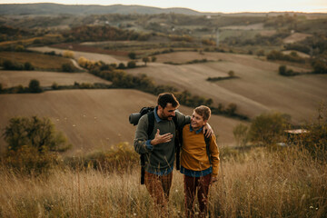 Happy family: father and children son on a nature hike at sunset. People and landscape concept