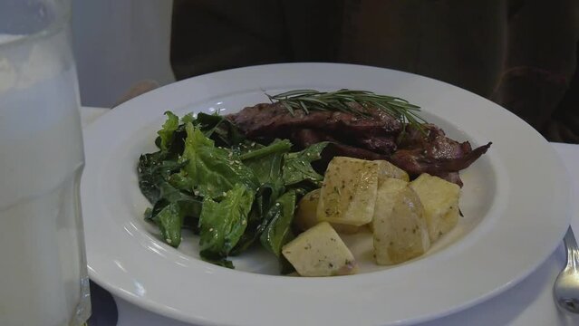 Grilled veal with spinach and toscana potatoes in a italian restaurant. Bogota, Colombia