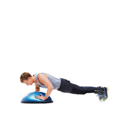Fototapeta na wymiar He understands the importance of exercise. A handsome young man using a bosu-ball for an upper body workout.