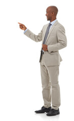 Pointing the way. An African-American businessman pointing towards copyspace.