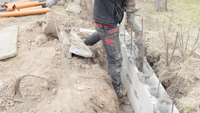 concreting from the pipe of the foundation of the building from the lost formwork
