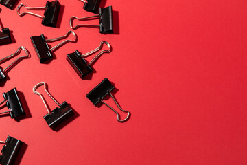 metal black binder clips on a red background