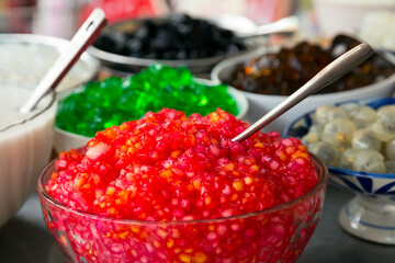 Close up of bowls of colourful jelly and tapioca dishes at a street market Hoi An in Vietnam