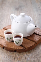 Tea is an aromatic beverage prepared by pouring hot or boiling water over cured or fresh leaves of...