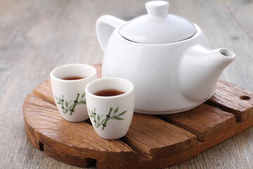 Tea is an aromatic beverage prepared by pouring hot or boiling water over cured or fresh leaves of...