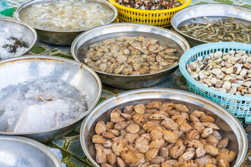 Cloe up of steel bowls of shellfish at a market in Vihn Luong in Vietnam