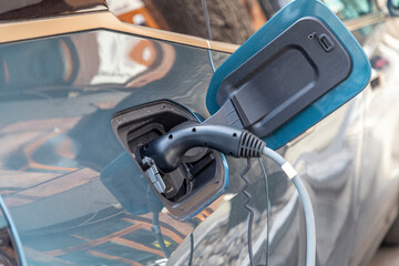 Charging modern electric car battery on the street which are the future of the Automobile, Close up...