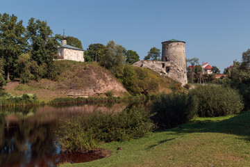 Fototapeta na wymiar Gremyachaya fortress tower and the ancient Church of Kozma and Damian in Pskov.