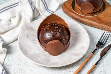 Chocolate cake. Bakery desserts. Delicious round portion cake with cream and dragee filling