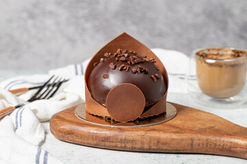 Chocolate cake. Bakery desserts. Delicious round portion cake with cream and dragee filling