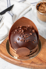 Chocolate cake. Bakery desserts. Delicious round portion cake with cream and dragee filling. Close up