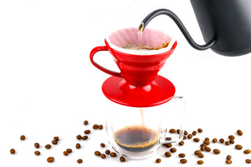 dripping coffee in red drip cup and the coffee water flows into the clear coffee cup below and there are coffee bean around ,  isolated on white background
