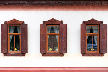 Three windows with wooden shutters in Kyiv Ukraine