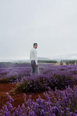 Man standing in purple lavender fields, editorial shoot, Tasmania Australia