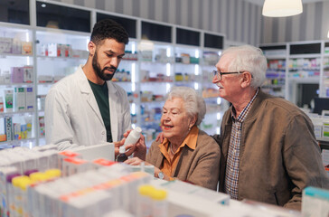 Fototapeta na wymiar Young pharmacist helping senior couple to choos medication.