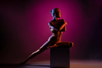 Naked woman close breast under color light