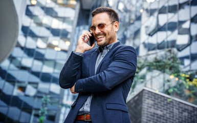Businessman making a phone call in front of the corporation. Business, lifestyle concept