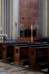 Monumental church building in Gothic in neo-romanesque arch style with large ceiling and altar murals and fresco, opulent detailed columns and marble structures