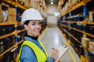 Warehouse female worker checking up stuff in a warehouse.