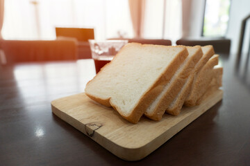 Fototapeta na wymiar Wooden board with tasty breakfast toasts on table, slice hole wheat bread breakfast in morning.